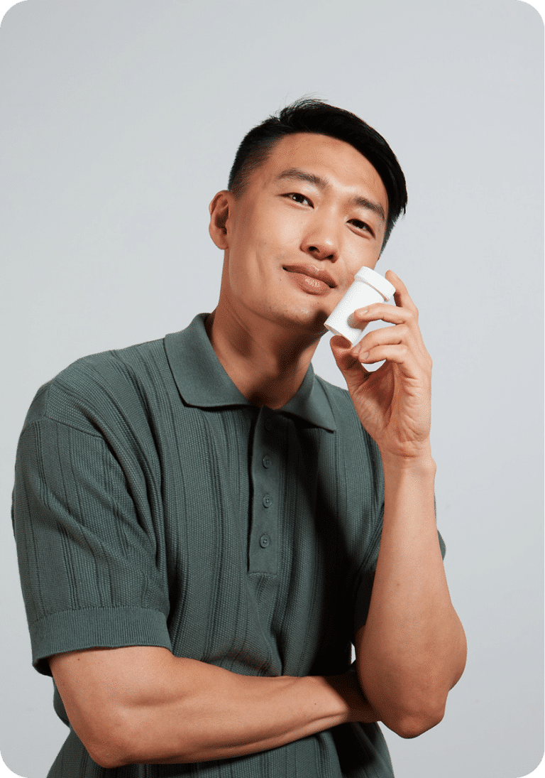 Person holding a Felix container to their cheek