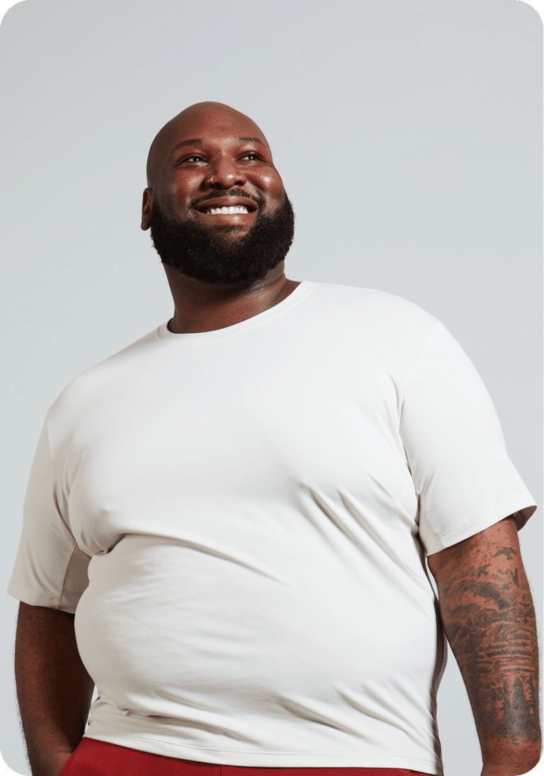 Person in a cream t-shirt looking upward