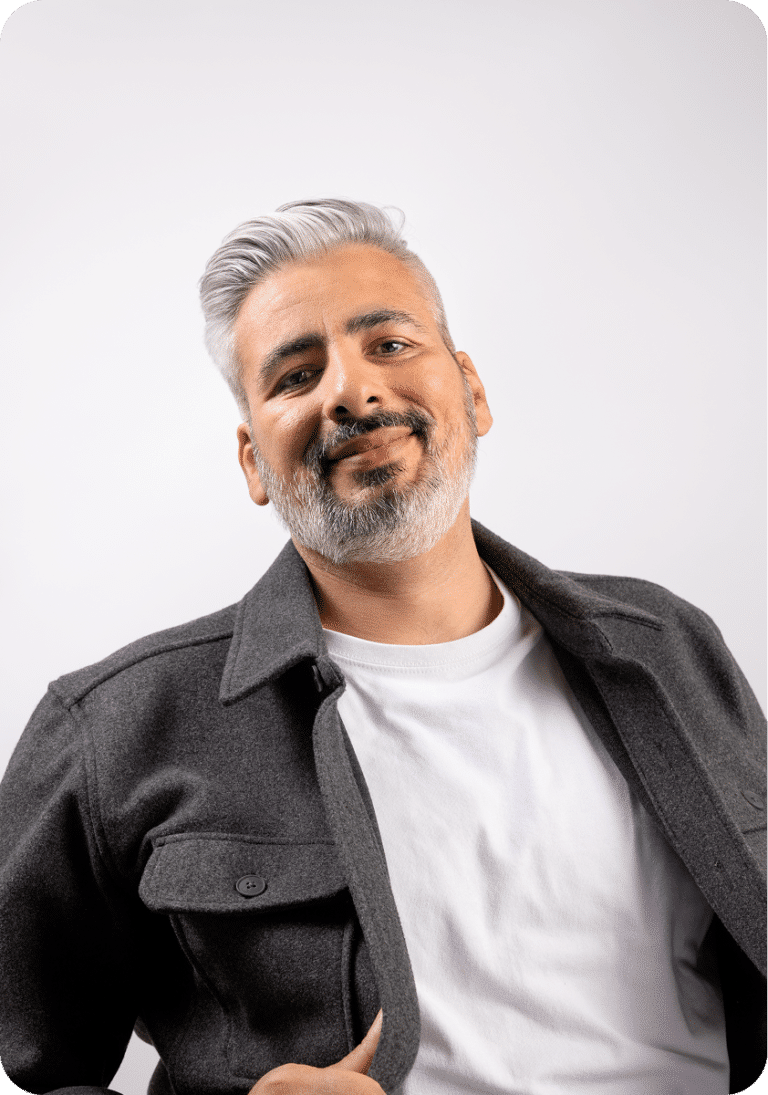 Person in a grey overshirt smiling