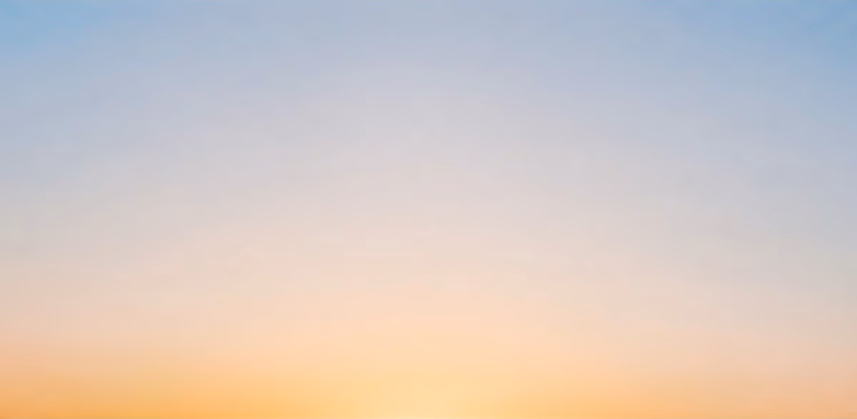 Pale blue sky fading to a warm glow at the horizon
